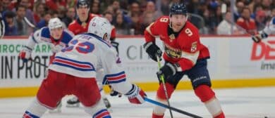 Florida Panthers center Sam Bennett (9) moves the puck as New York Rangers defenseman Adam Fox (23) defends during the second period at Amerant Bank Arena.
