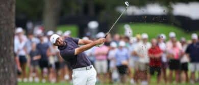 Scottie Scheffler plays his shot from the third fairway during the third round of the TOUR Championship golf tournament