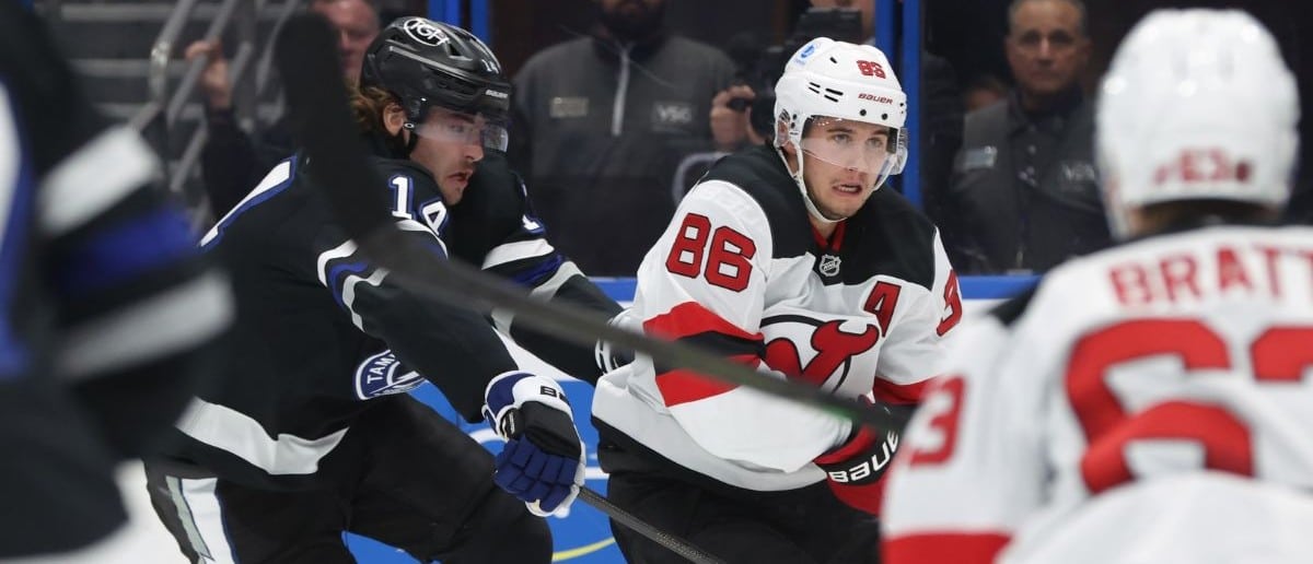 New Jersey Devils center Jack Hughes (86) skates with the puck as Tampa Bay Lightning center Conor Geekie (14) defends during the second period at Benchmark International Arena