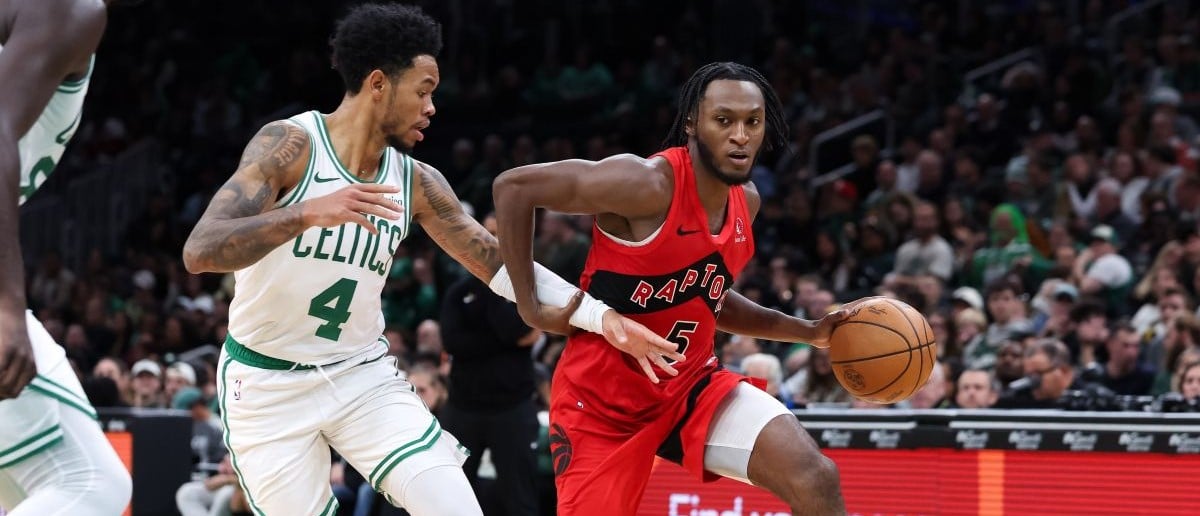 Toronto Raptors guard Immanuel Quickley (5) drives to the basket defended by Boston Celtics guard Anfernee Simons (4) during the second half at TD Garden