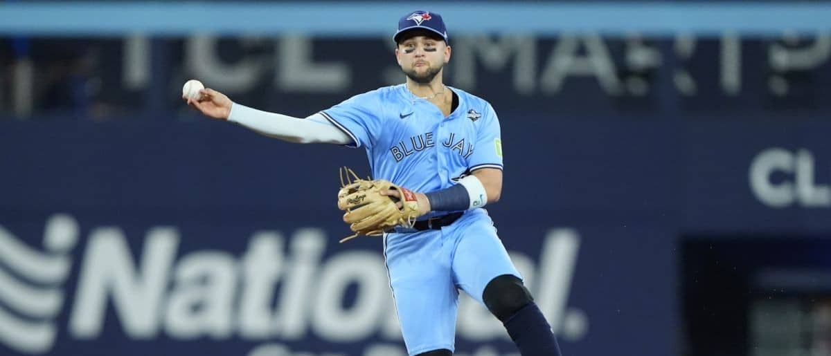 Toronto Blue Jays designated hitter Bo Bichette (11) throws out Los Angeles Dodgers shortstop Mookie Betts (50) in the sixth inning during game six of the 2025 MLB World Series at Rogers Centre.