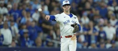 Toronto Blue Jays third baseman Ernie Clement (22) throws to first for an out against Los Angeles Dodgers second baseman Miguel Rojas (72) in the eleventh inning during game seven of the 2025 MLB World Series at Rogers Centre