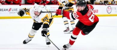New Jersey Devils center Jack Hughes (86) takes a shot on goal as Pittsburgh Penguins defenseman Erik Karlsson (65) defends during the first overtime period at Prudential Center.