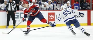Washington Capitals defenseman John Carlson (74) shoots the puck as Toronto Maple Leafs center Nicolas Roy (55) defends during the third period at Capital One Arena