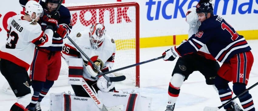 Winnipeg Jets forward Jonathan Toews (19) tries to deflect the puck past Ottawa Senators goalie Linus Ullmark (35) during the third period at Canada Life Centre.