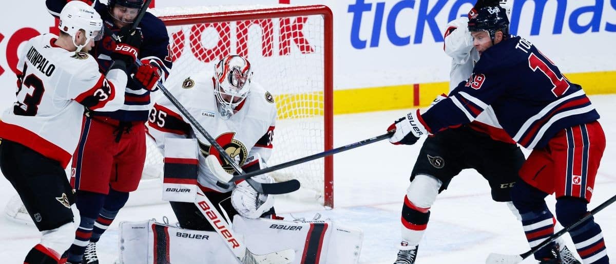 Winnipeg Jets forward Jonathan Toews (19) tries to deflect the puck past Ottawa Senators goalie Linus Ullmark (35) during the third period at Canada Life Centre.
