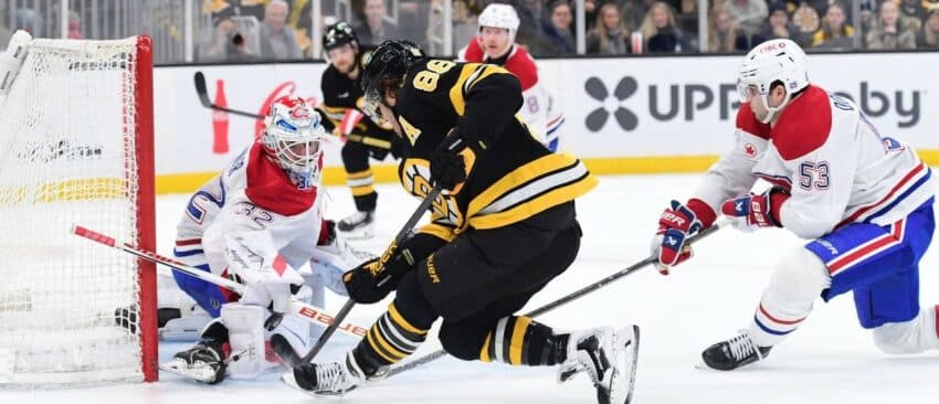 Montreal Canadians goaltender Jacob Fowler (32) makes a save on Boston Bruins right wing David Pastrnak (88) while defenseman Noah Dobson (53) defense during the first period at TD Garden