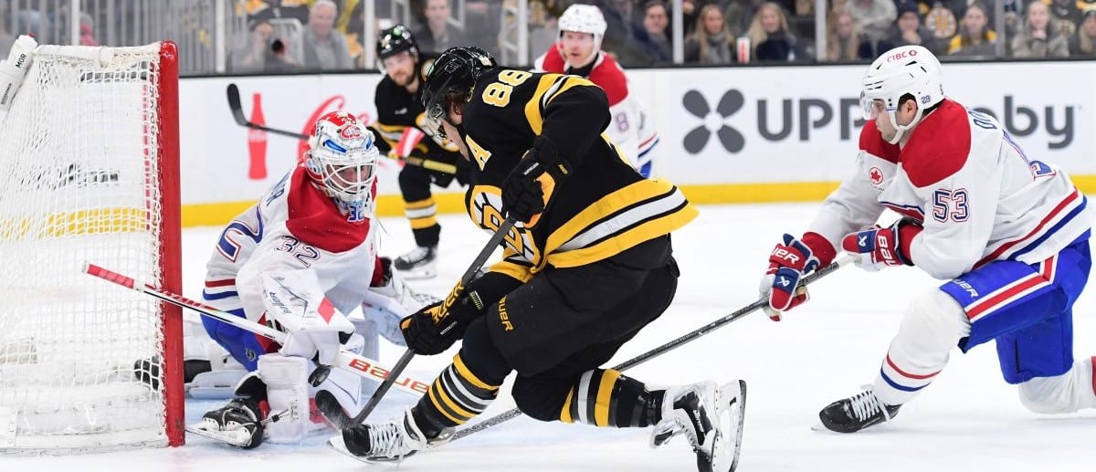 Montreal Canadians goaltender Jacob Fowler (32) makes a save on Boston Bruins right wing David Pastrnak (88) while defenseman Noah Dobson (53) defense during the first period at TD Garden