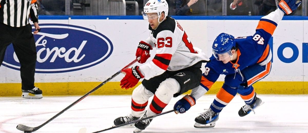 New Jersey Devils left wing Jesper Bratt (63) makes a move around New York Islanders defenseman Matthew Schaefer (48) during the third period at UBS Arena