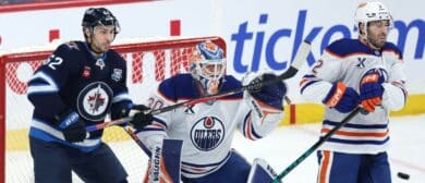 Winnipeg Jets right wing Nino Niederreiter (62) and Edmonton Oilers defenseman Evan Bouchard (2) watch a shot on Edmonton Oilers goaltender Calvin Pickard (30) in the third period at Canada Life Centre.