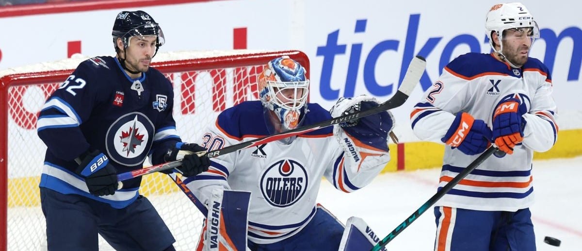 Winnipeg Jets right wing Nino Niederreiter (62) and Edmonton Oilers defenseman Evan Bouchard (2) watch a shot on Edmonton Oilers goaltender Calvin Pickard (30) in the third period at Canada Life Centre.