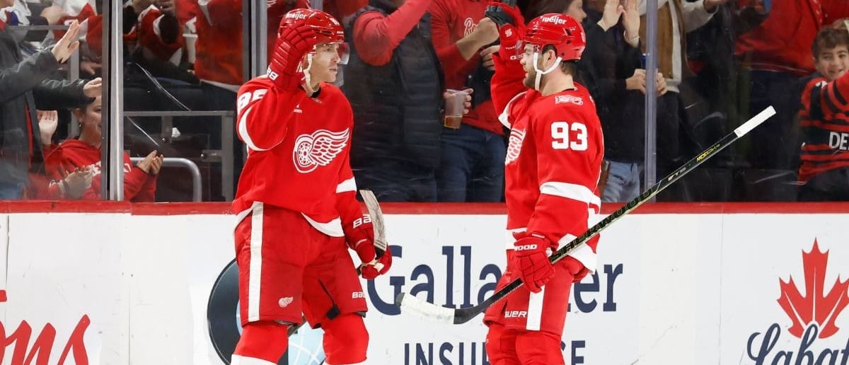 Detroit Red Wings right wing Patrick Kane (88) celebrates with right wing Alex Debrincat (93) after scoring in the first period against the Vancouver Canucks at Little Caesars Arena.