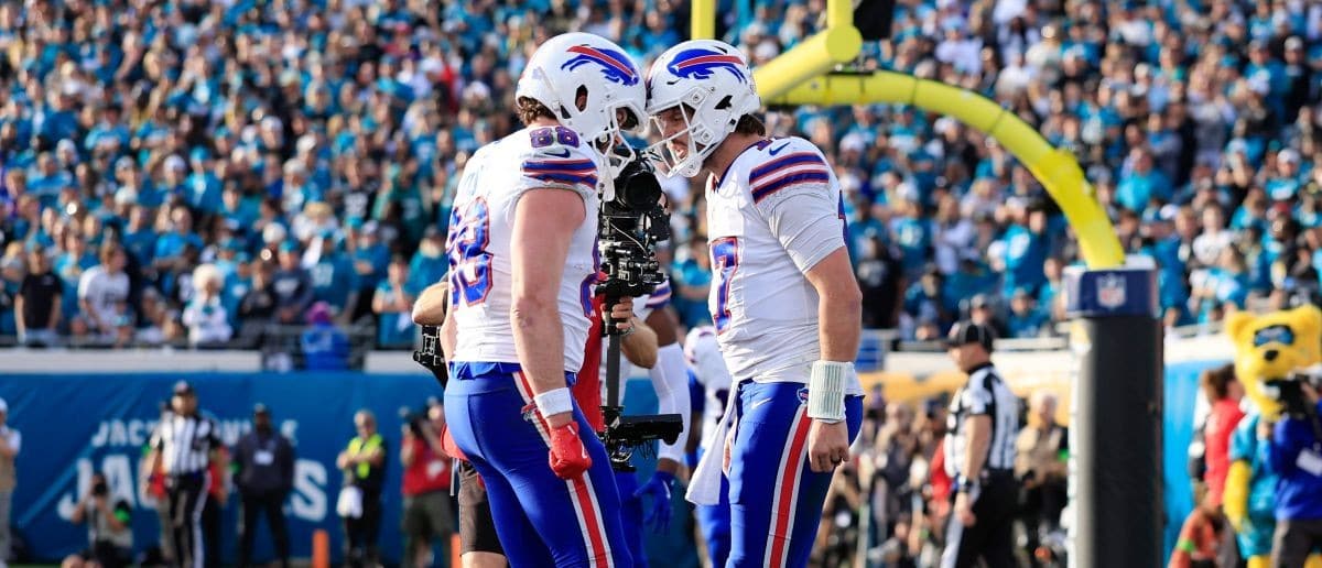 Buffalo Bills quarterback Josh Allen (17), right, celebrates his touchdown with teammate tight end Dawson Knox (88) during the fourth quarter of an NFL football AFC Wild Card playoff matchup, Sunday, Jan. 11, 2026, in Jacksonville, Fla. The Bills defeated the Jaguars 27-24