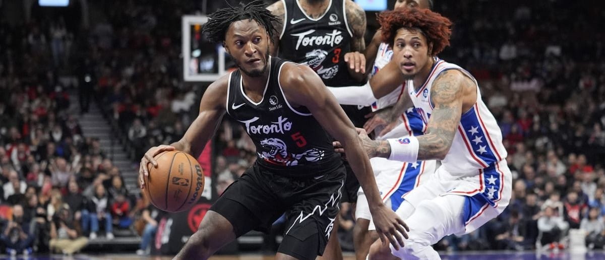Toronto Raptors guard Immanuel Quickley (5) dribbles around Philadelphia 76ers forward Kelly Oubre Jr. (9) during the second half at Scotiabank Arena