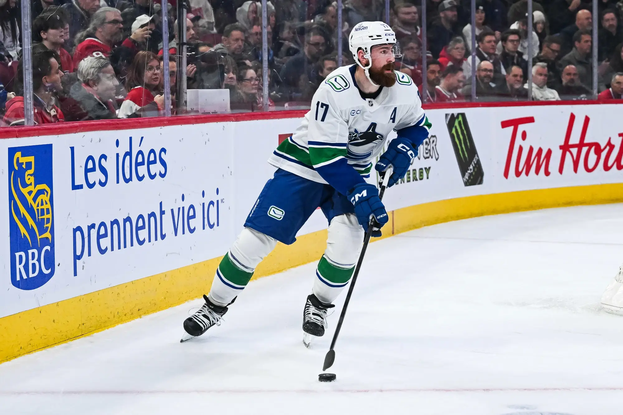 Jan 12, 2026; Montreal, Quebec, CAN; Vancouver Canucks defenseman Filip Hronek (17) plays the puck against the Montreal Canadiens during the second period at Bell Centre.