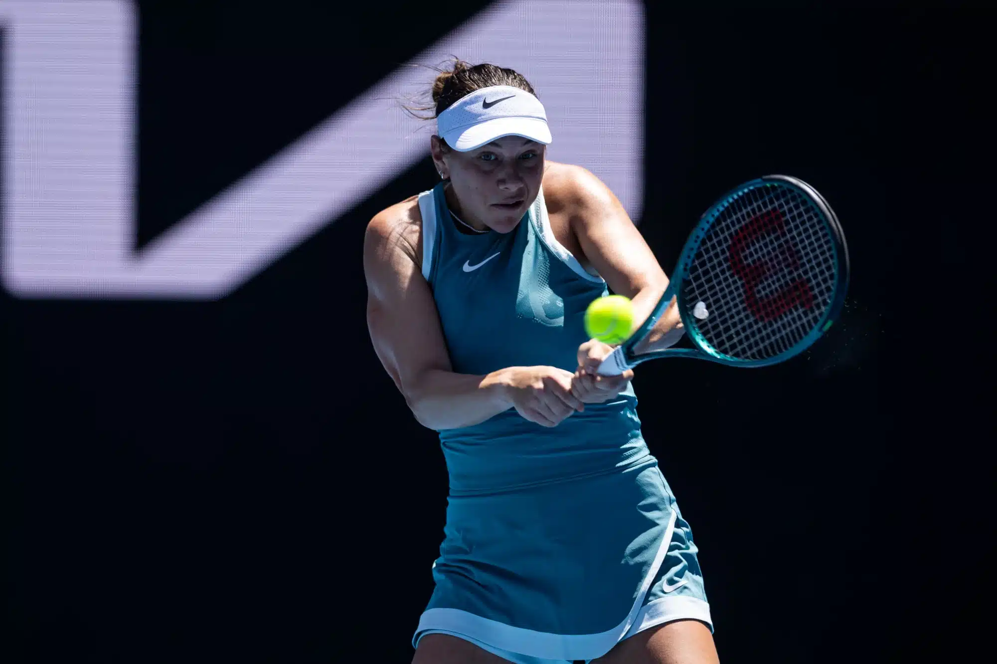 Jan 16, 2025; Melbourne, Victoria, Australia; Amanda Anisimova of United States of America plays a backhand during her match against Emma Raducanu of United Kingdom in the second round of the women's singles at the 2025 Australian Open at Melbourne Park.