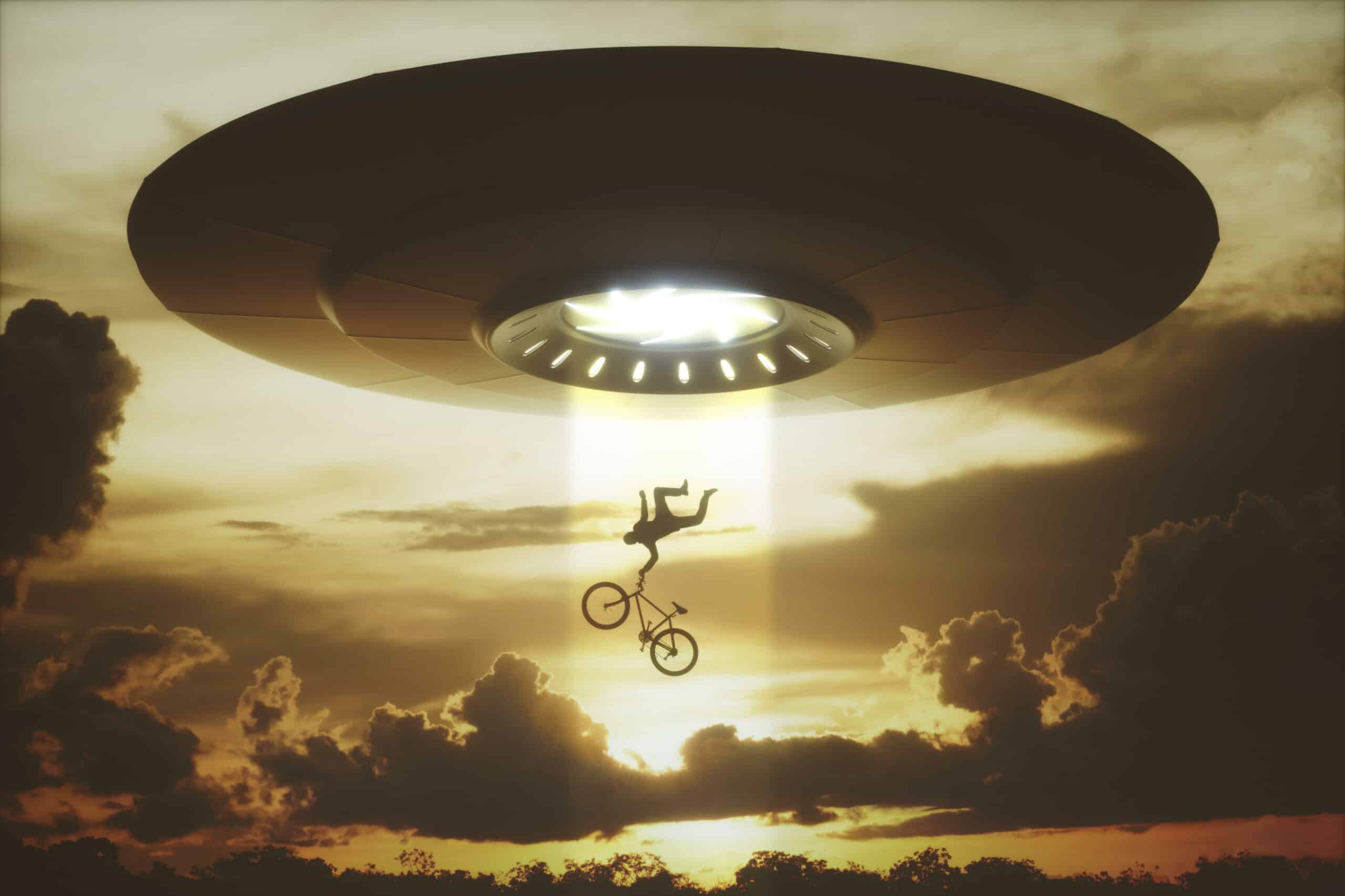 Conceptual illustration of a UFO beaming up a person on a bicycle against a sunset sky.