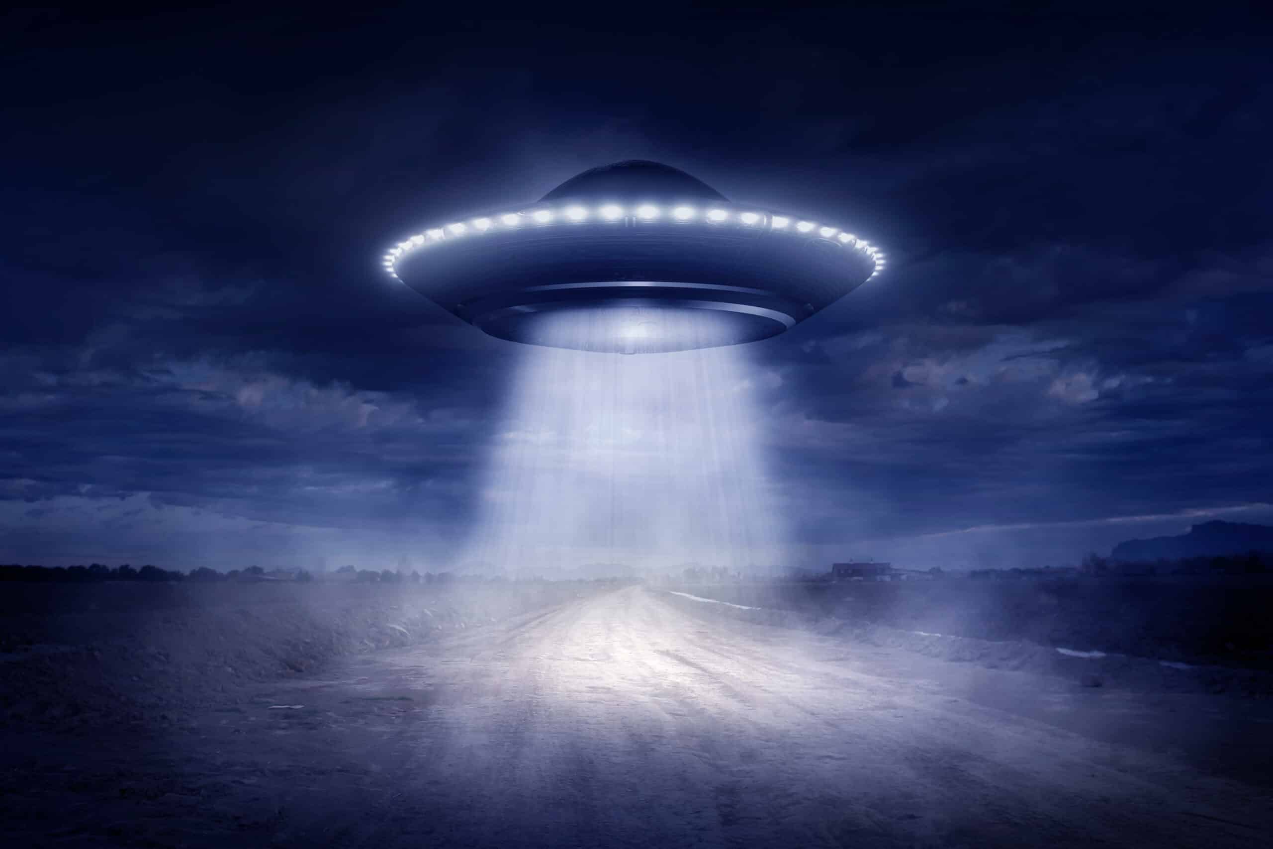 UFO hovering above a rural road at night, illustrating the Alien Abduction Odds Index 2026 and regional UFO hotspot rankings.