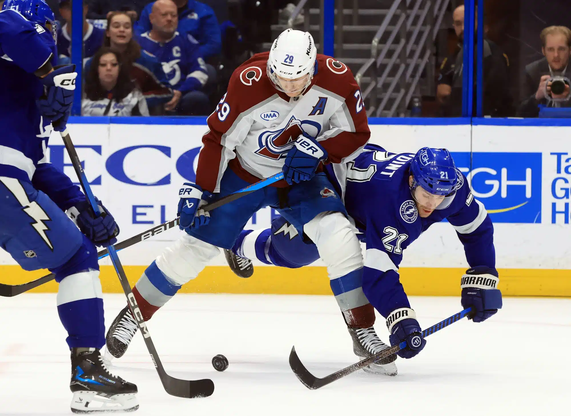 Jan 6, 2026; Tampa, Florida, USA; Colorado Avalanche center Nathan MacKinnon (29) skates with the puck as Tampa Bay Lightning center Brayden Point (21) attempted to defend during the second period at Benchmark International Arena.