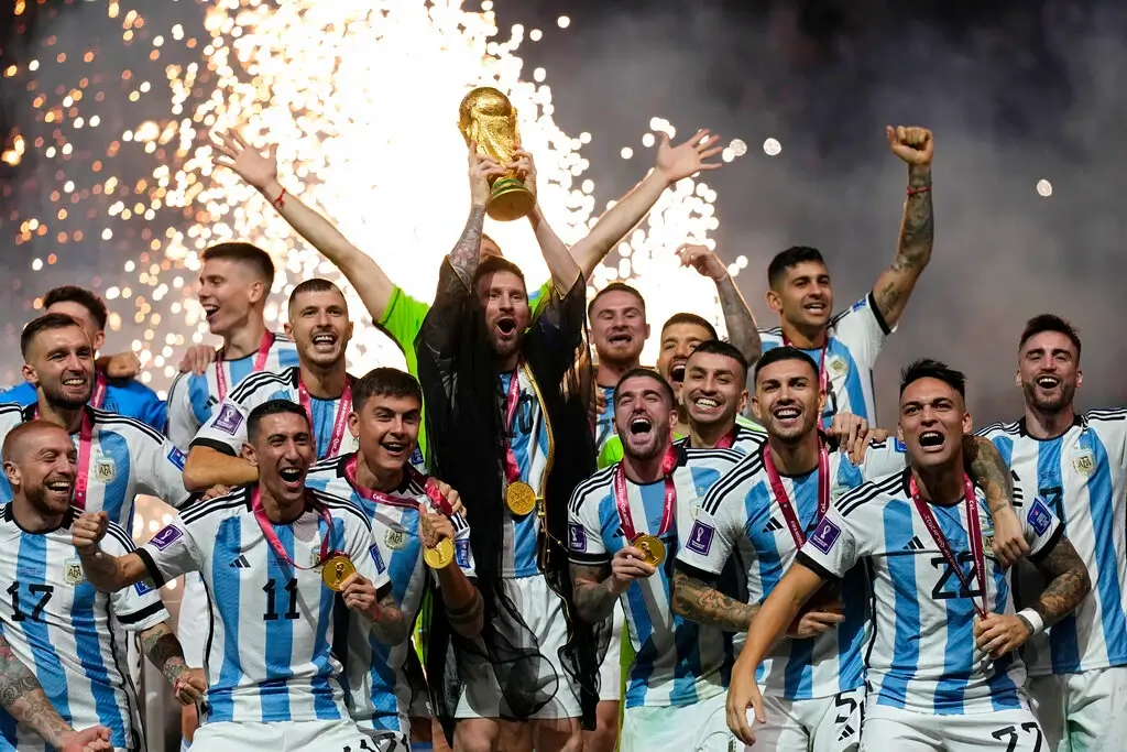 Argentina's Lionel Messi lifts the trophy after winning the World Cup final soccer match between Argentina and France at the Lusail Stadium in Lusail, Qatar, Sunday, Dec. 18, 2022.