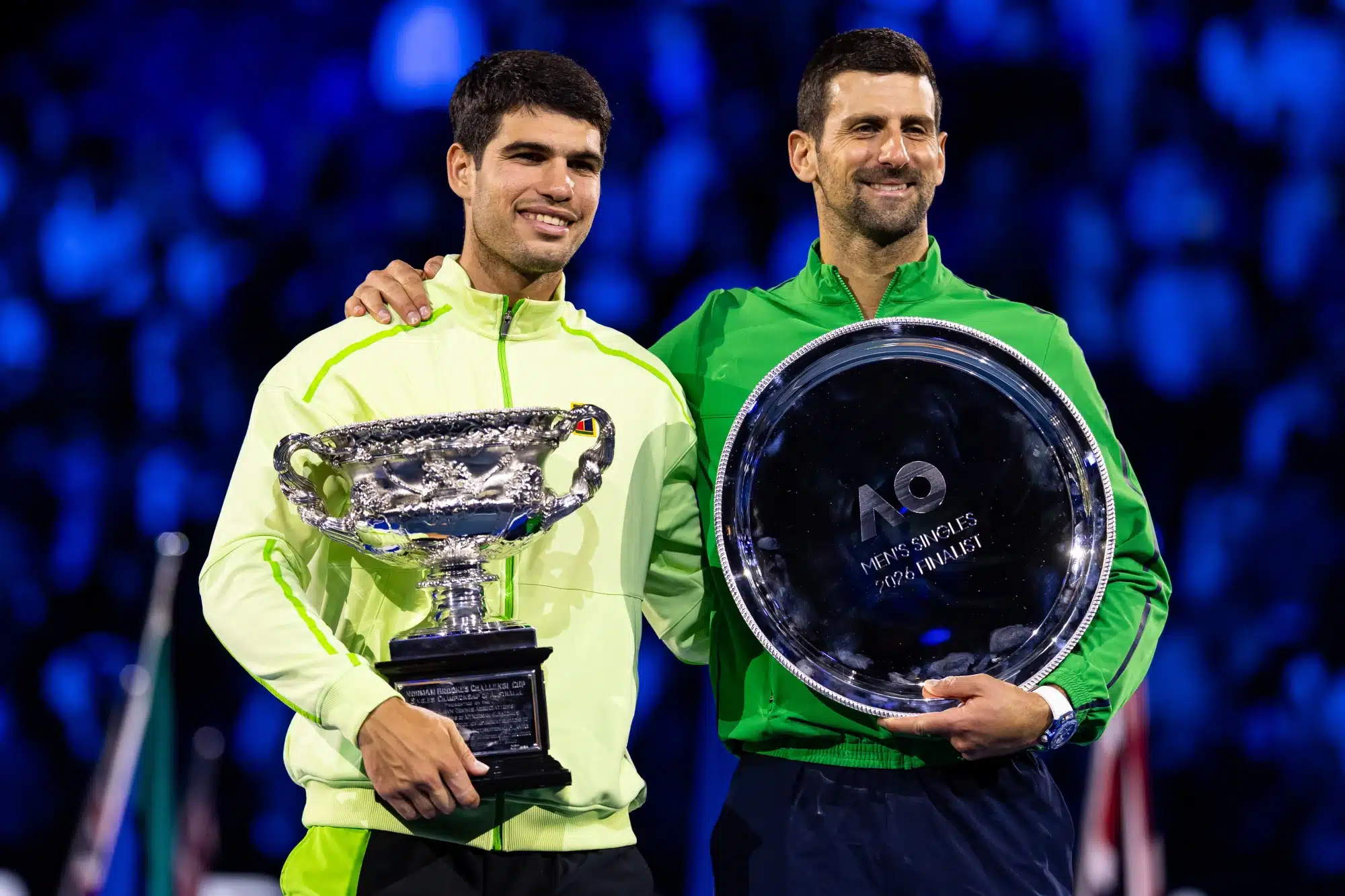 Feb 01, 2026; Melbourne, Victoria, Australia; Carlos Alcaraz of Spain and Novak Djokovic of Serbia during the trophy presentation after the final of the menís singles at the Australian Open at Rod Laver Arena in Melbourne Park.