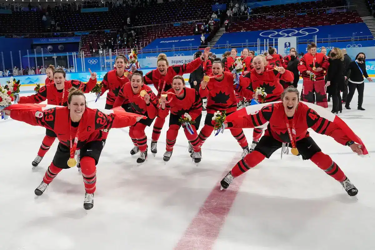 Team Canada woemns hockey team celebrates after winning women's hockey gold at the Beijing Olympics, on Feb. 17, 2022.