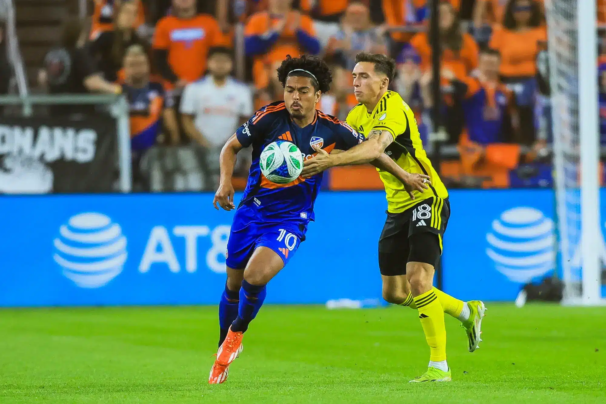 Nov 8, 2025; Cincinnati, Ohio, USA; FC Cincinnati forward Evander (10) battles for the ball against Columbus Crew defender Malte Amundsen (18) in the first half at TQL Stadium.