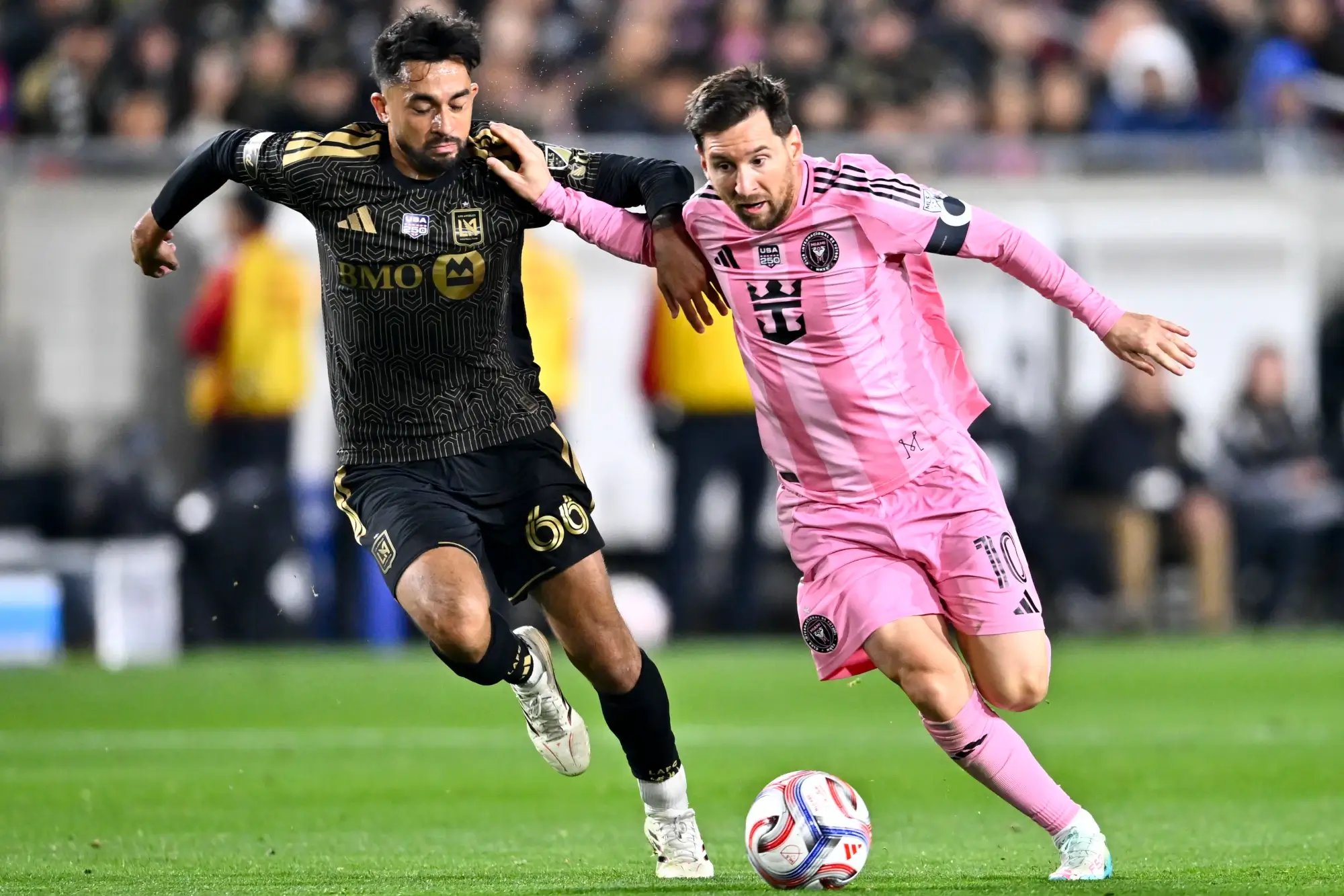 Feb 21, 2026; Los Angeles, California, USA; Inter Miami CF forward Lionel Messi (10) moves the ball against Los Angeles FC midfielder Mathieu Choinière (66) during the second half at Los Angeles Memorial Coliseum.