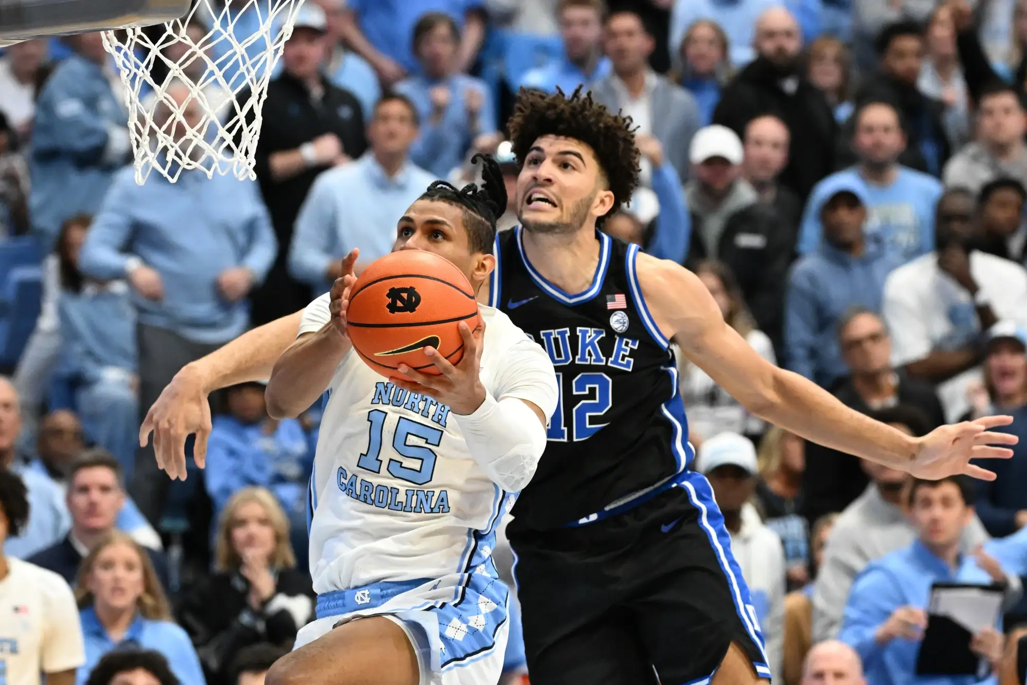 Feb 7, 2026; Chapel Hill, North Carolina, USA; North Carolina Tar Heels forward Jarin Stevenson (15) shoots as Duke Blue Devils forward Cameron Boozer (12) defends in the second half at Dean E. Smith Center.