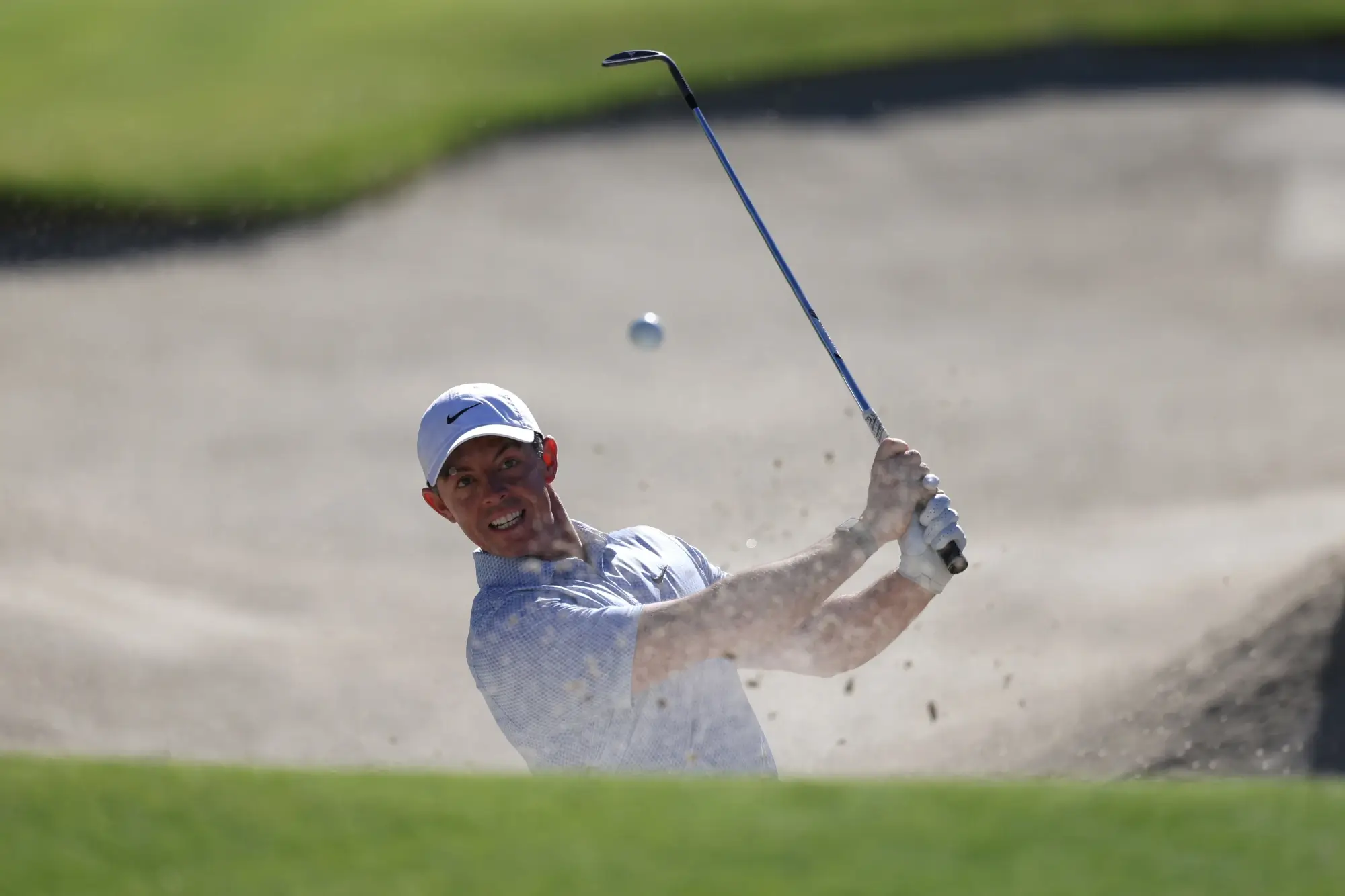Feb 22, 2026; Pacific Palisades, California, USA; Rory McIlroy hits his bunker shot on the 17th hole during the final round of the The Genesis Invitational golf tournament at Riviera Country Club. 