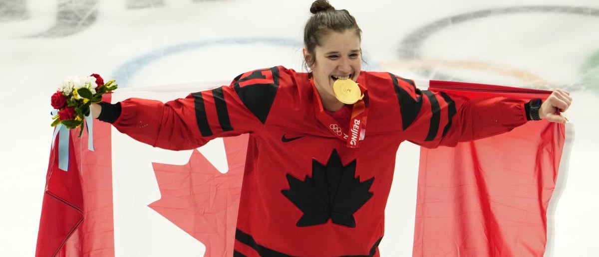 Team Canada forward Jamie Lee Rattray (47) celebrates with her gold medal after the medals ceremony during the Beijing 2022 Olympic Winter Games at Wukesong Sports Centre