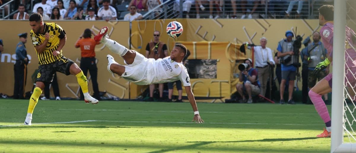 Real Madrid CF forward Kylian Mbappe (9) scores a goal against Borussia Dortmund goalkeeper Gregor Kobel (1) in the second half during a quarterfinal match of the 2025 FIFA Club World Cup at MetLife Stadium.