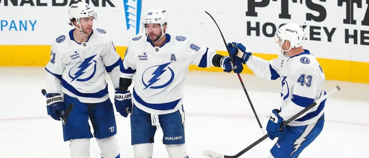 Tampa Bay Lightning right wing Nikita Kucherov (86) celebrates with center Brayden Point (21) and defenseman Darren Raddysh (43) after scoring a goal against the Vegas Golden Knights during the third period at T-Mobile Arena