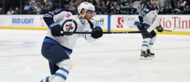 Winnipeg Jets left wing Kyle Connor (81) holds the follow through on a shot that scores a goal against the Utah Mammoth during the second period at Delta Center
