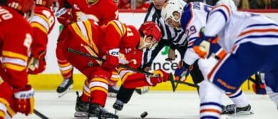 Calgary Flames center Mikael Backlund (11) and Edmonton Oilers center Leon Draisaitl (29) face off for the puck during the third period at Scotiabank Saddledome