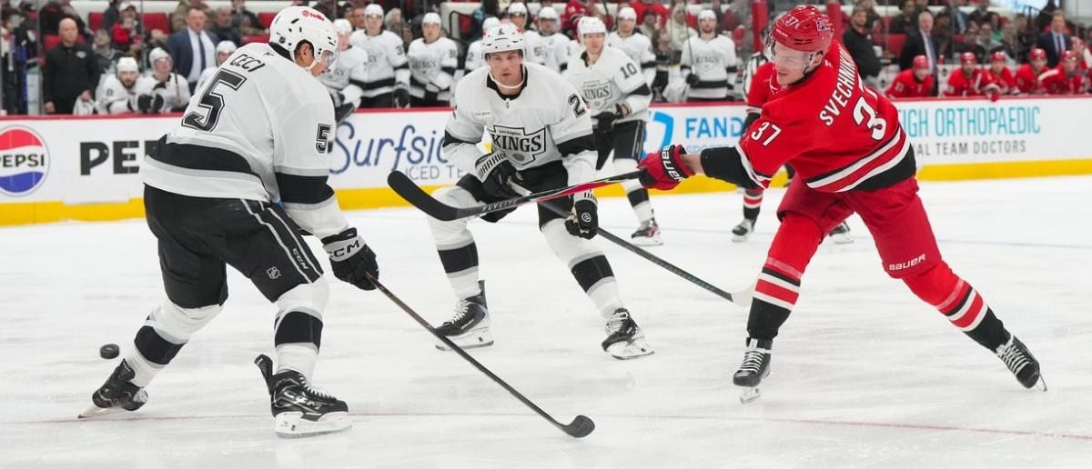 Carolina Hurricanes right wing Andrei Svechnikov (37) gets the shot away against Los Angeles Kings defenseman Cody Ceci (5) and defenseman Brian Dumoulin (2) during the third period at Lenovo Center.