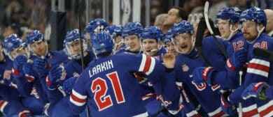Dylan Larkin (21) of the United States celebrates with teammates after scoring a goal against Sweden in a men's ice hockey quarterfinal during the Milano Cortina 2026 Olympic Winter Games at Milano Santagiulia Ice Hockey Arena.