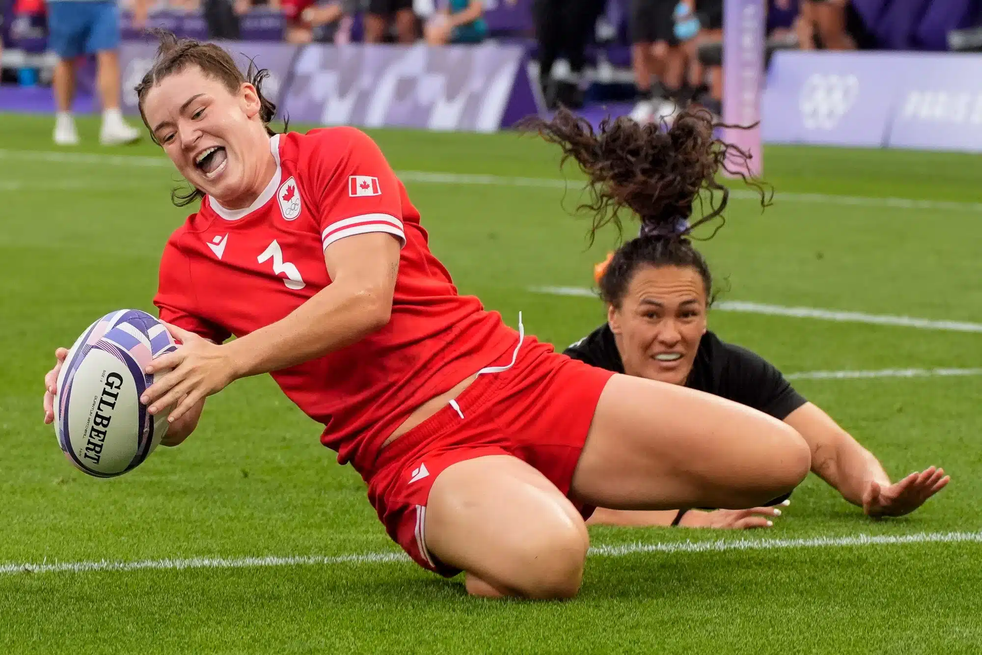 Canada forward Alysha Corrigan (3) scores a try past New Zealand back Portia Woodman-Wickliffe (11) in the rugby sevens gold medal match at the Paris 2024 Olympic Summer Games at Stade de France in Saint-Denis, France, Tuesday, July 30, 2024.