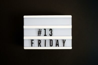 Lightbox sign displaying “#13 Friday” on a black background, symbolizing Friday the 13th superstition.