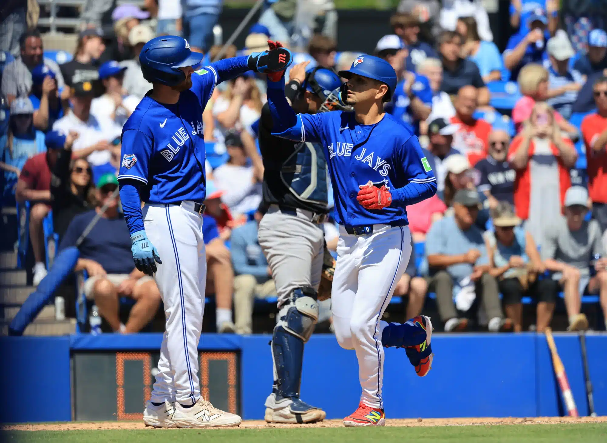 Mar 19, 2026; Dunedin, Florida, USA; Toronto Blue Jays second baseman Andres Gimenez (0) is congratulated after hitting a two-run home run during the fifth inning against the New York Yankees at TD Ballpark.