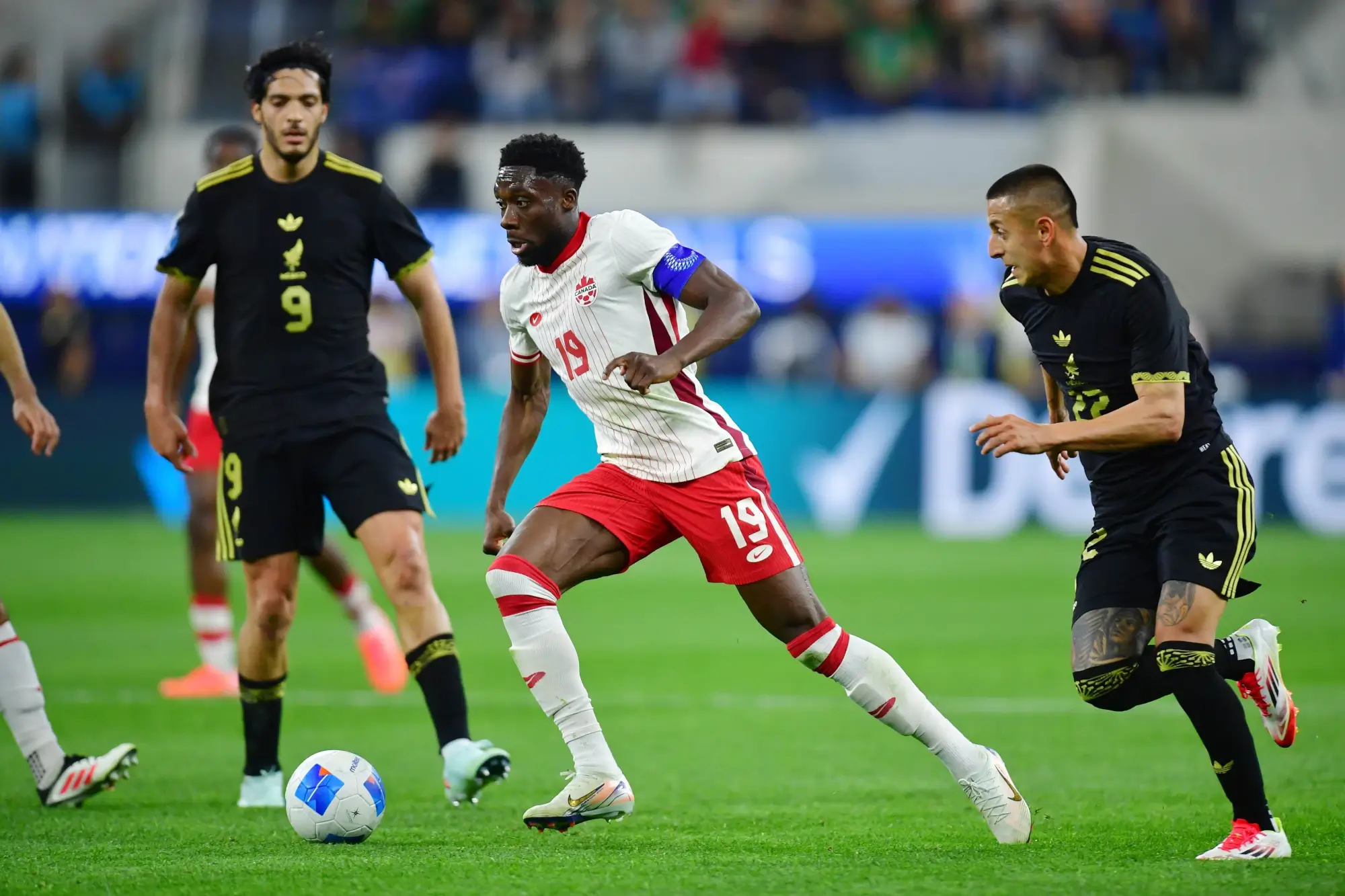 Mar 20, 2025; Inglewood, California, USA; Canada defender Alphonso Davies (19) dribbles the ball against Mexico during the second half of a Concacaf Nations League semifinal match at SoFi Stadium. 