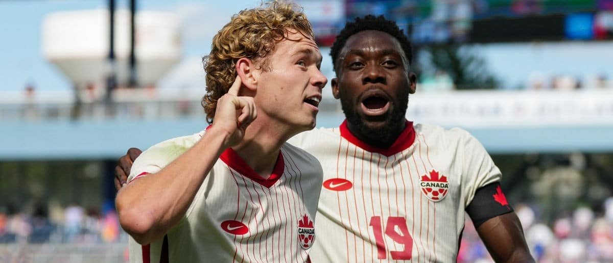 Canada forward Jacob Shaffelburg (14) celebrates with defender Alphonso Davies (19) after scoring a goal during the first half against the United States at Children’s Mercy Park