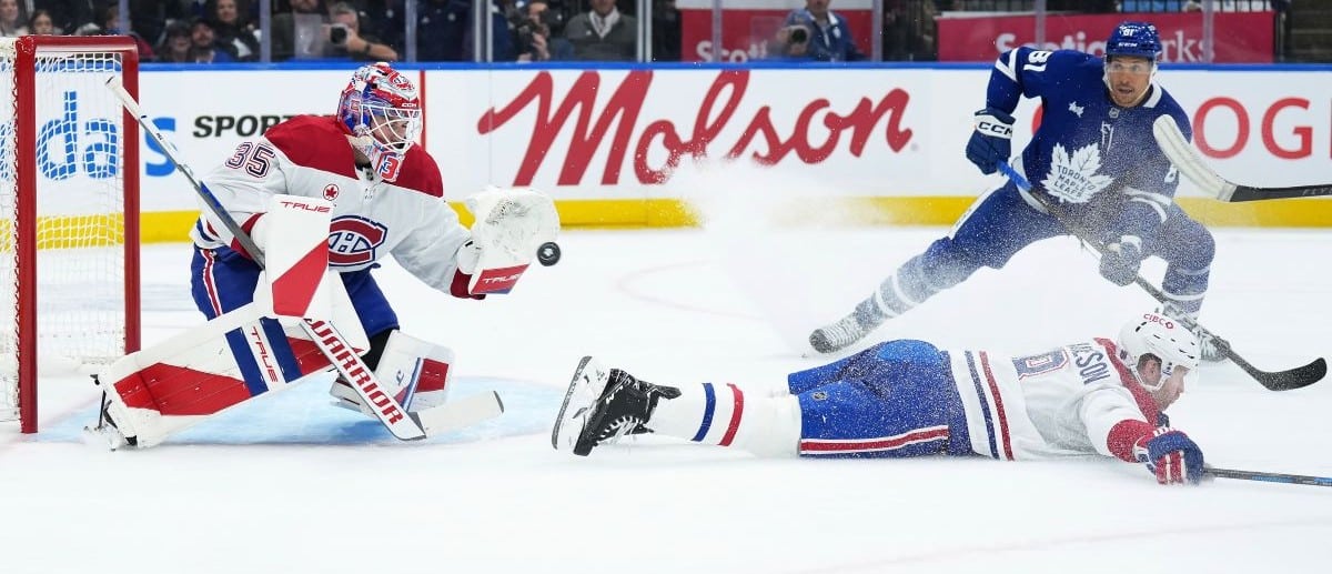 Montreal Canadiens goaltender Sam Montembeault (35) stops the puck as Toronto Maple Leafs center Dakota Joshua (81) looks for the rebound during the first period at Scotiabank Arena.
