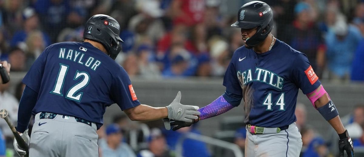 Seattle Mariners center fielder Julio Rodriguez (44) celebrates with first baseman Josh Naylor (12) after hitting a home run in the third inning against the Toronto Blue Jays during game seven of the ALCS round for the 2025 MLB playoffs at Rogers Centre