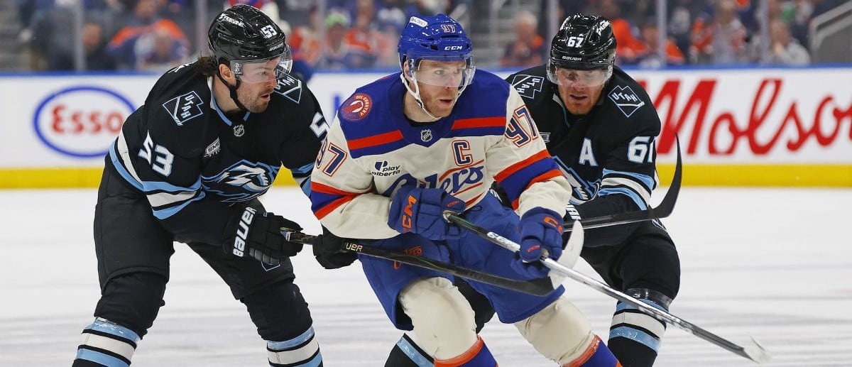 Edmonton Oilers forward Connor McDavid (97) carries the puck past Utah Mammoth forward Michael Carcone (53) and Utah Mammoth forward Lawson Crouse (67) during the third period at Rogers Place.
