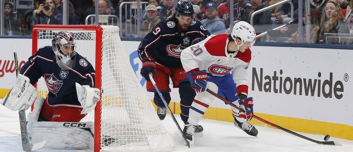 Montreal Canadiens left wing Juraj Slafkovsky (20) and Columbus Blue Jackets defenseman Ivan Provorov (9) battle for the puck during the first period at Nationwide Arena.
