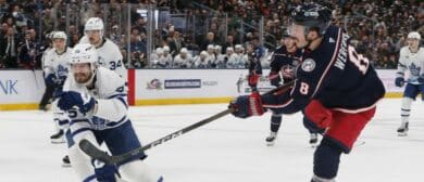 Columbus Blue Jackets defenseman Zach Werenski (8) wrists a shot on goal as Toronto Maple Leafs center Nicolas Roy (55) defends during the second period at Nationwide Arena.
