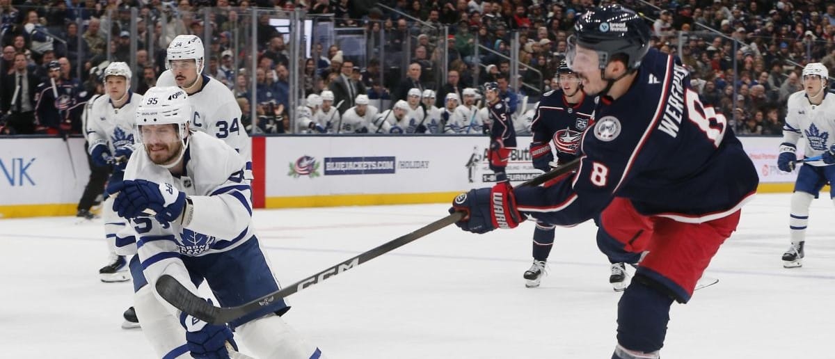 Columbus Blue Jackets defenseman Zach Werenski (8) wrists a shot on goal as Toronto Maple Leafs center Nicolas Roy (55) defends during the second period at Nationwide Arena.