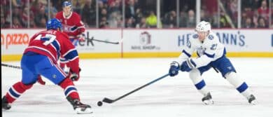 Tampa Bay Lightning forward Brayden Point (21) plays the puck and Montreal Canadiens defenseman Jayden Struble (47) defends during the first period at the Bell Centre