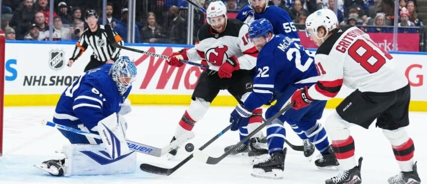 Toronto Maple Leafs defenseman Jake McCabe (22) battles for the puck with New Jersey Devils right wing Arseny Gritsyuk (81) during the second period at Scotiabank Arena.